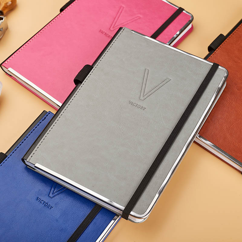 A5 pu with another pu on spine stitched diary.agendar with elastic band  and tri-side metal frame D 39040