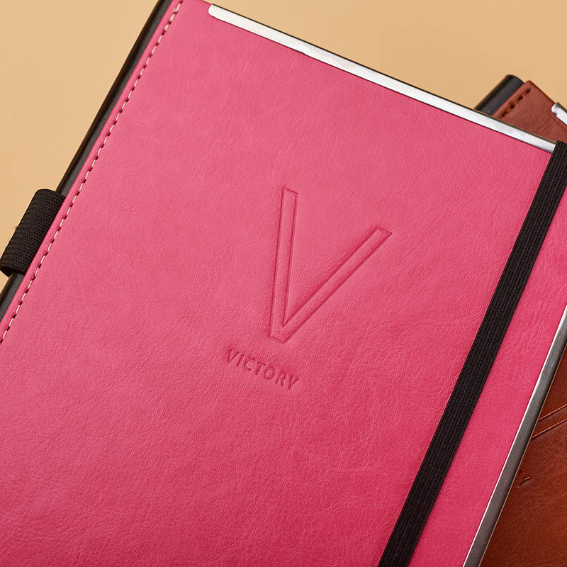 A5 pu with another pu on spine stitched diary.agendar with elastic band  and tri-side metal frame D 39040